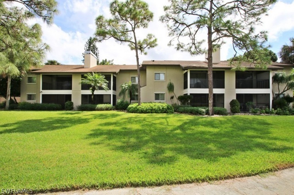 16740 Partridge Place Road, Unit 204 Fort Myers, FL 33908 - Photo 5 of 25 a front view of a house with a yard