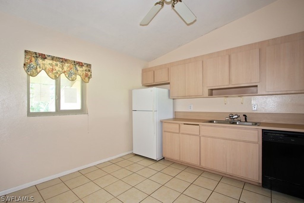 16740 Partridge Place Road, Unit 204 Fort Myers, FL 33908 - Photo 9 of 25 a kitchen with a stove a sink and a refrigerator