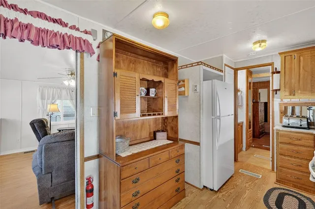 a kitchen with refrigerator and window