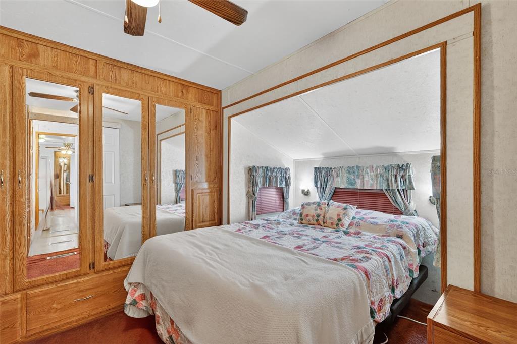 11324 Goldfinch Way Leesburg, FL 34788 - Photo 15 of 20 a bedroom with a large bed and a large window