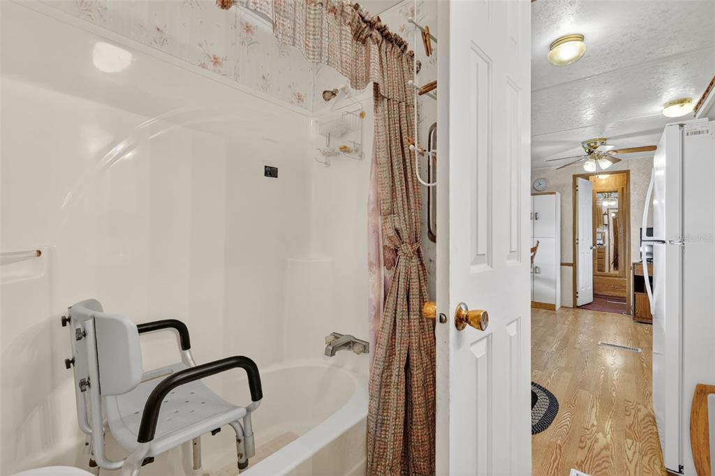 11324 Goldfinch Way Leesburg, FL 34788 - Photo 19 of 20 a bathroom with a granite countertop shower