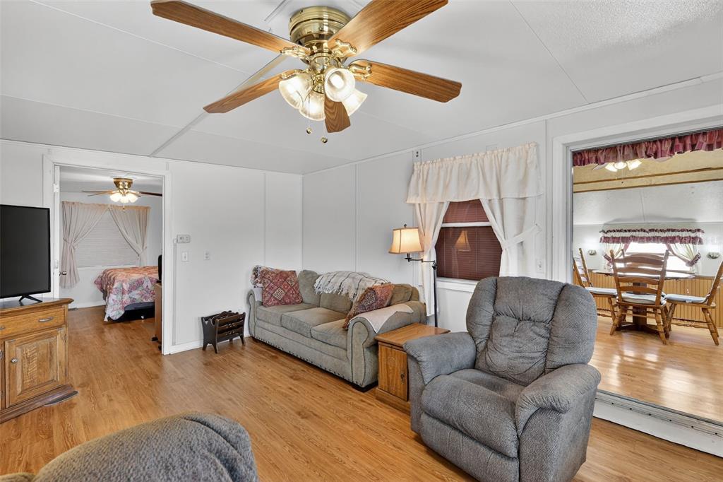 11324 Goldfinch Way Leesburg, FL 34788 - Photo 6 of 20 a living room with furniture and a wooden floor