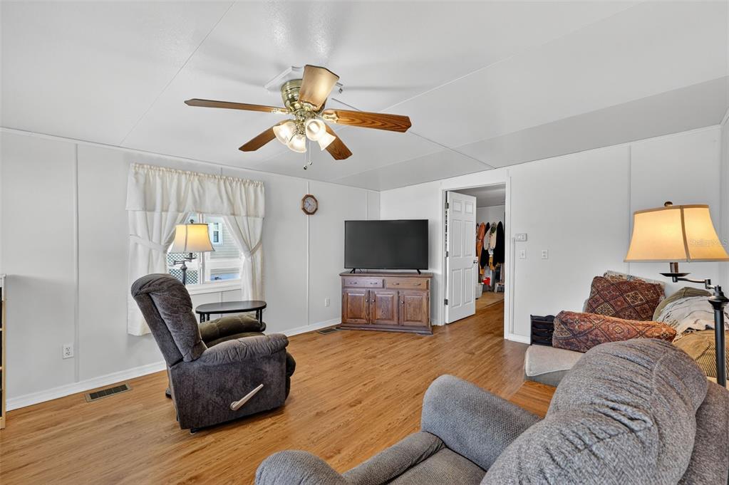 11324 Goldfinch Way Leesburg, FL 34788 - Photo 7 of 20 a living room with furniture and a flat screen tv