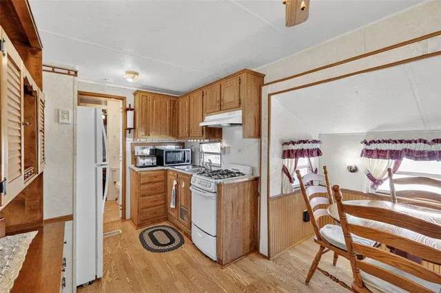 a kitchen with stainless steel appliances granite countertop a refrigerator and a stove top oven