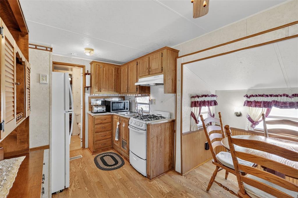 11324 Goldfinch Way Leesburg, FL 34788 - Photo 10 of 20 a kitchen with stainless steel appliances granite countertop a refrigerator and a stove top oven