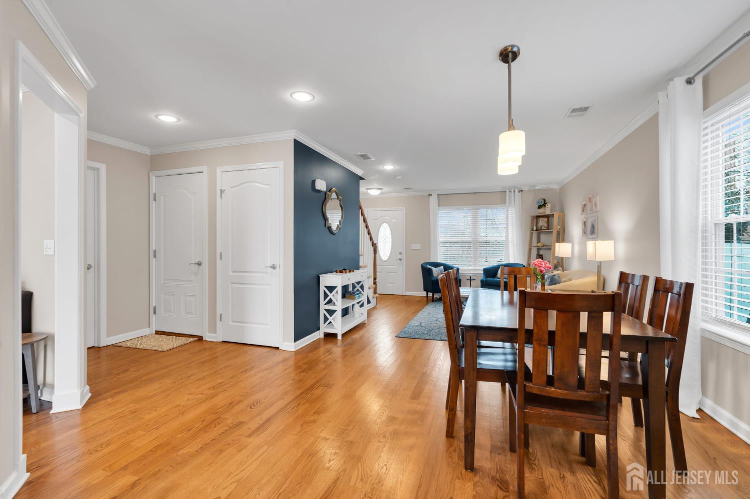 3 Harrison Avenue Aberdeen, NJ 07747 - Photo 11 of 46 a view of a dining room and livingroom with furniture wooden floor a chandelier
