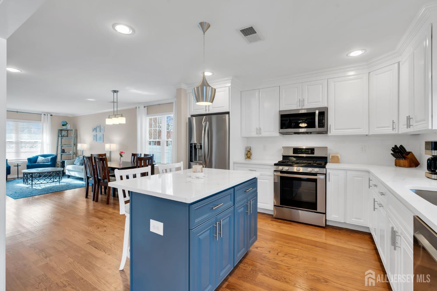3 Harrison Avenue Aberdeen, NJ 07747 - Photo 13 of 46 a kitchen with kitchen island granite countertop a sink appliances and cabinets