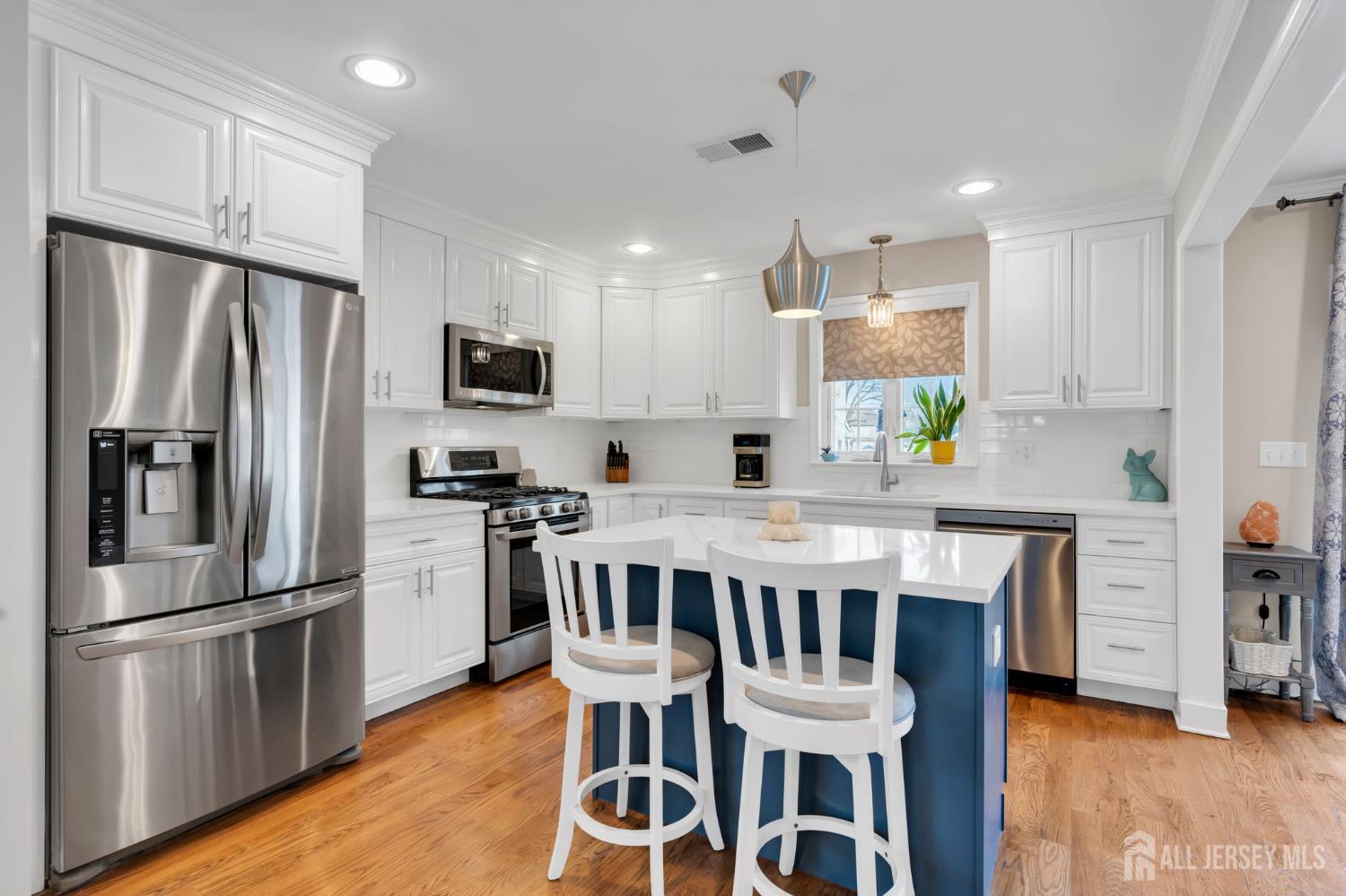 3 Harrison Avenue Aberdeen, NJ 07747 - Photo 15 of 46 a kitchen with stainless steel appliances granite countertop a dining table chairs refrigerator and microwave