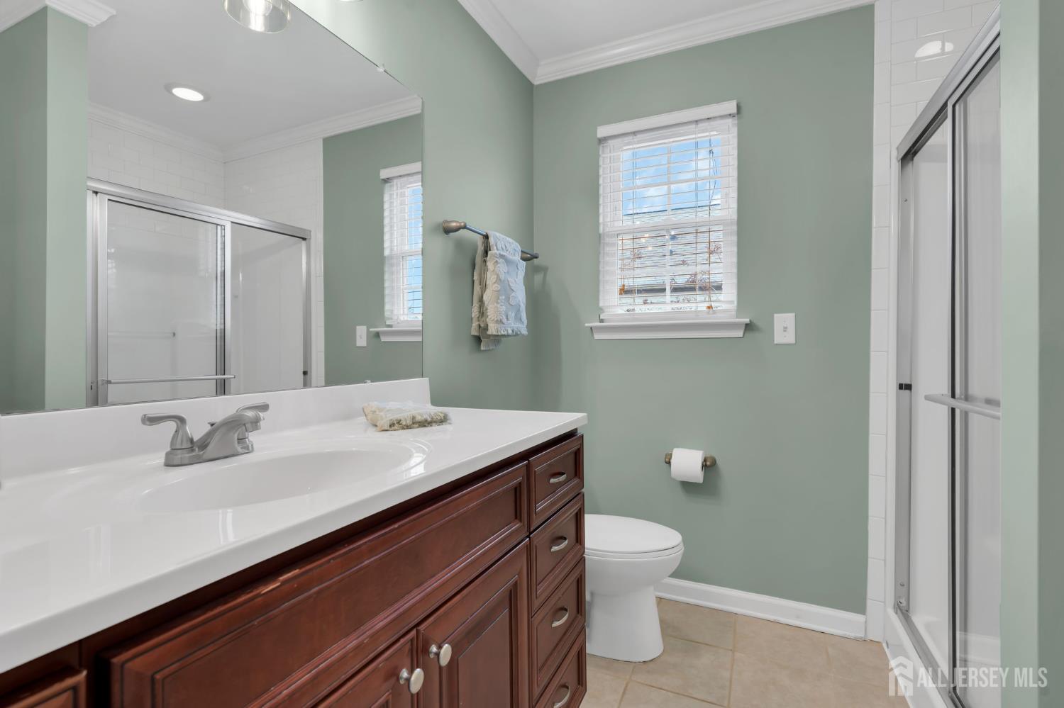 3 Harrison Avenue Aberdeen, NJ 07747 - Photo 28 of 46 a bathroom with a sink a toilet and shower
