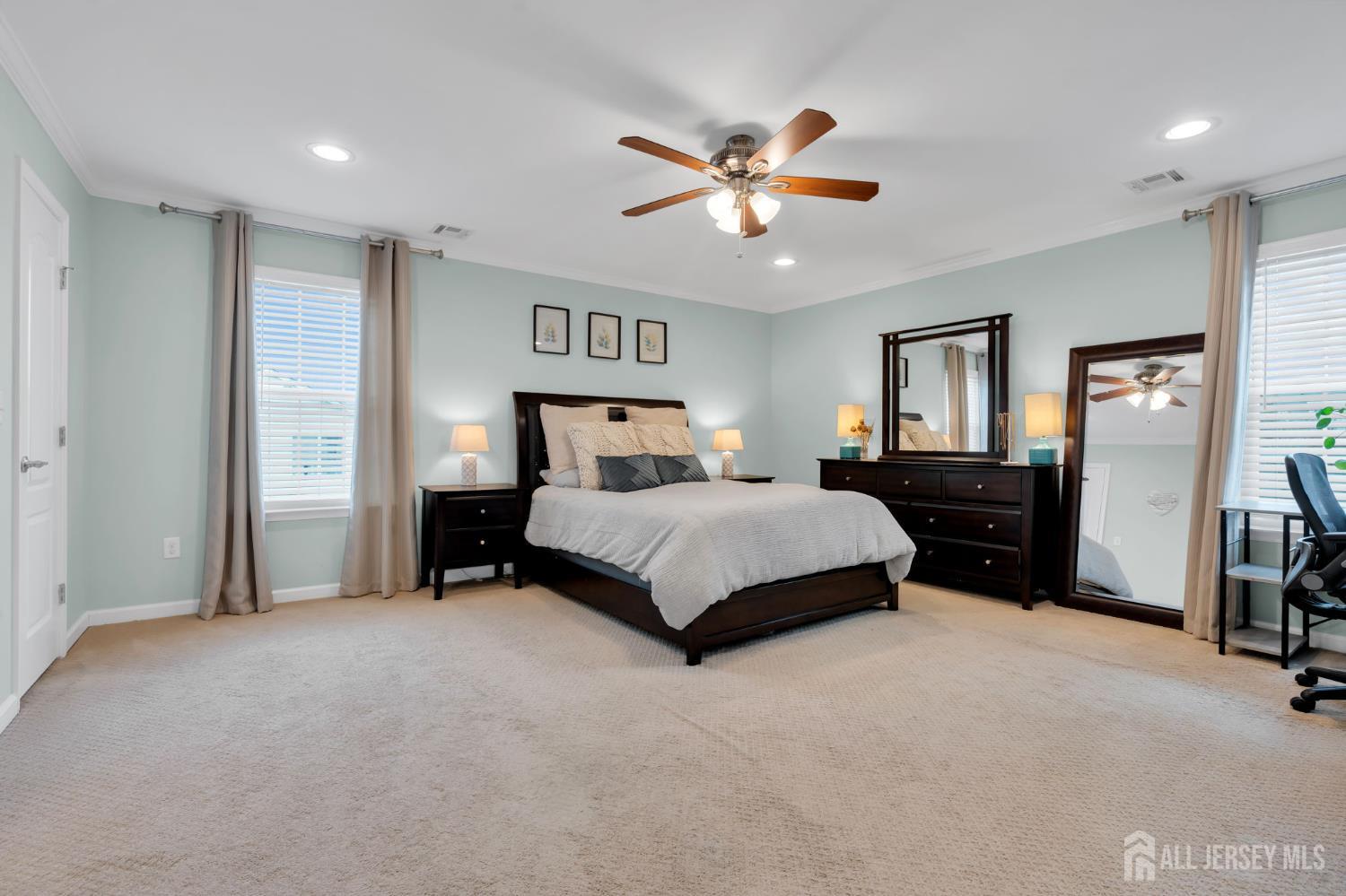3 Harrison Avenue Aberdeen, NJ 07747 - Photo 29 of 46 a bedroom with a bed and a chandelier