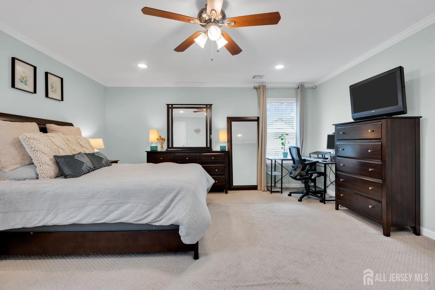 3 Harrison Avenue Aberdeen, NJ 07747 - Photo 30 of 46 a spacious bedroom with a bed and a flat tv screen on dresser
