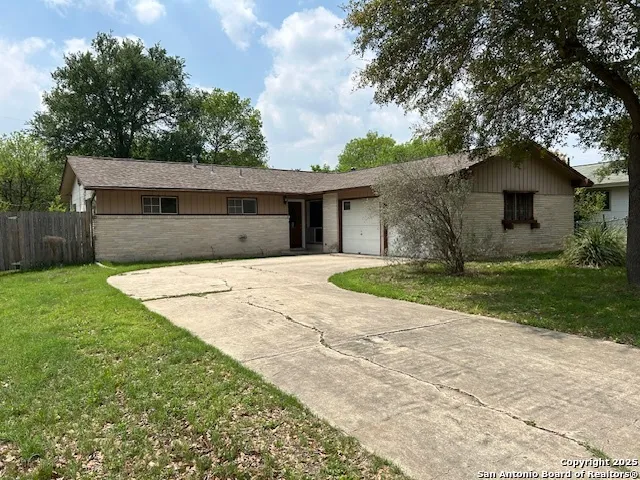 a front view of house with yard and trees