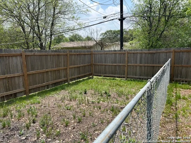 a view of a fence in a backyard