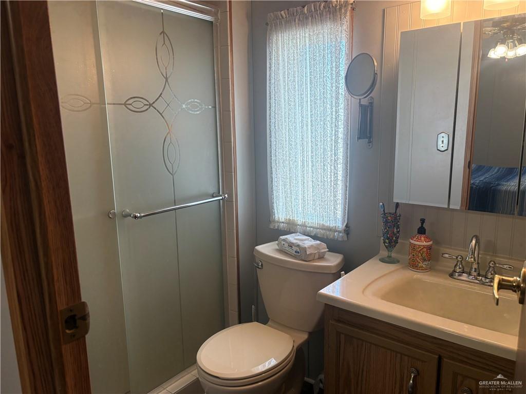 310 Randal Drive, Unit H12 Mission, TX 78572 - Photo 16 of 36 a white toilet sitting next to a bathroom sink