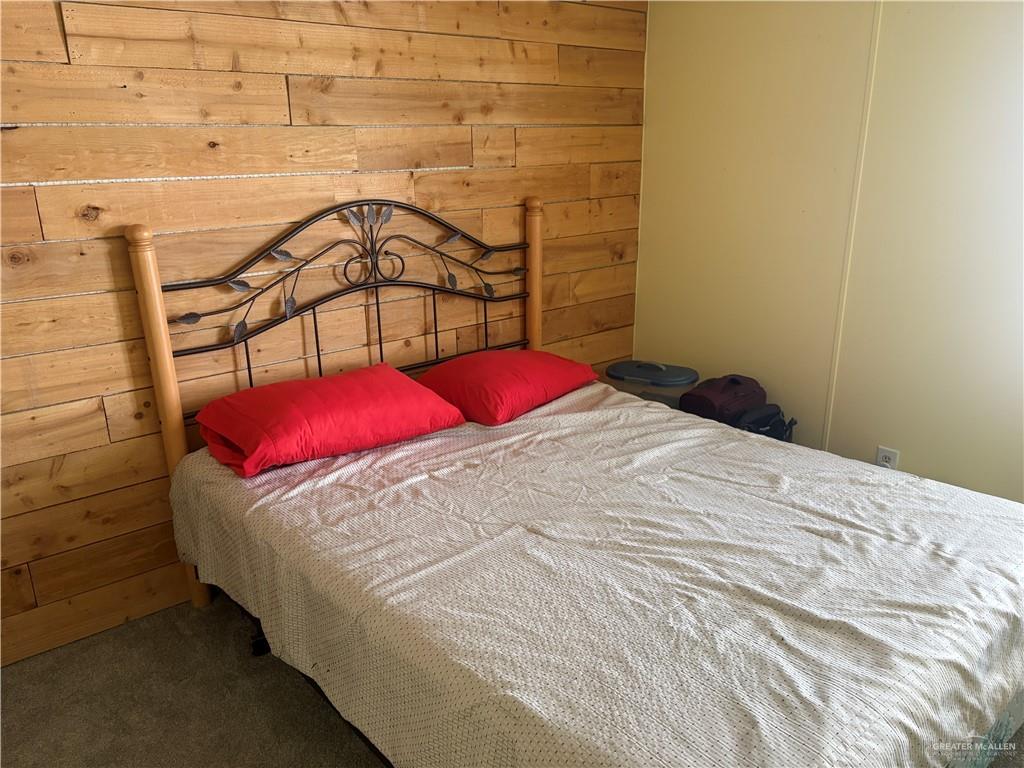 310 Randal Drive, Unit H12 Mission, TX 78572 - Photo 18 of 36 a bedroom with a bed and a mirror