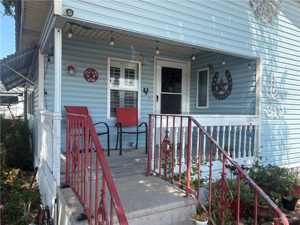 310 Randal Drive, Unit H12 Mission, TX 78572 - Photo 2 of 36 a view of a house with a door and wooden bench
