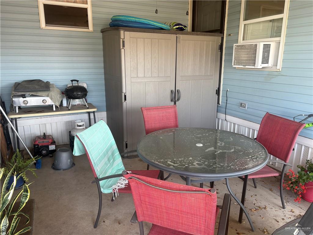 310 Randal Drive, Unit H12 Mission, TX 78572 - Photo 26 of 36 a dining room with furniture and wooden floor