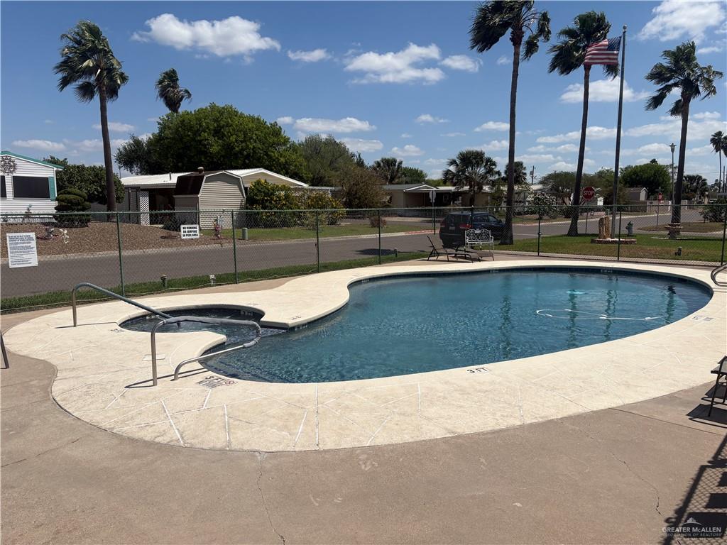 310 Randal Drive, Unit H12 Mission, TX 78572 - Photo 32 of 36 a swimming pool with outdoor seating