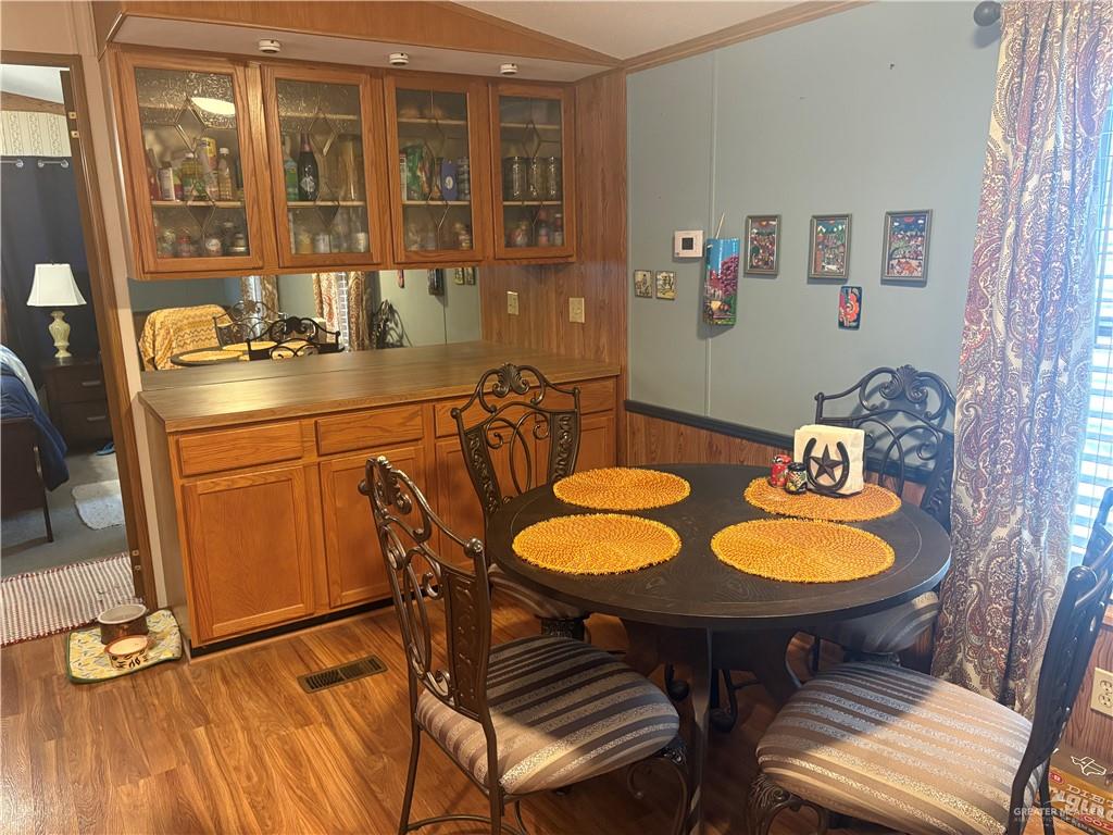 310 Randal Drive, Unit H12 Mission, TX 78572 - Photo 7 of 36 a dining room with furniture and wooden floor
