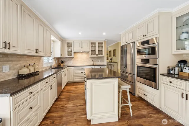 a kitchen with stainless steel appliances a refrigerator sink and cabinets