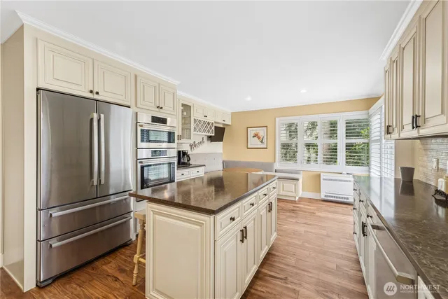 a kitchen with stainless steel appliances granite countertop a refrigerator and a sink
