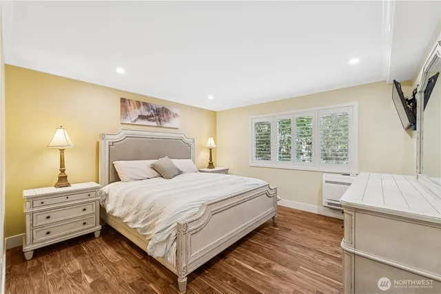 a bedroom with a bed and a large window