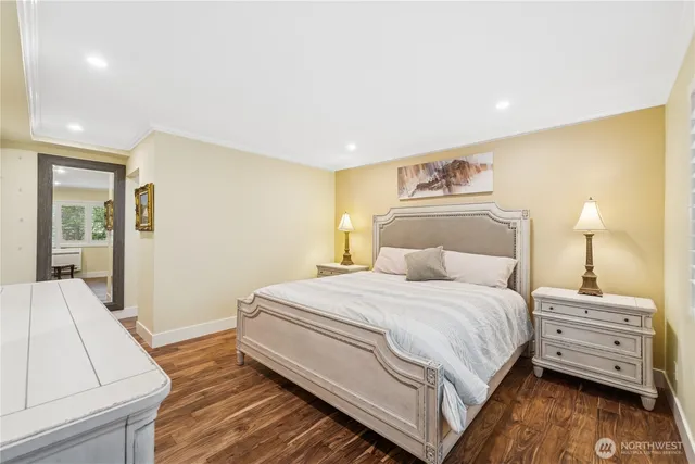 a bedroom with a bed and a night stand