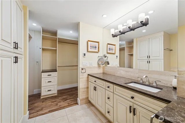 a spacious bathroom with a granite countertop sink mirror and shower