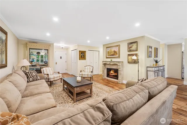 a living room with furniture large window and a fireplace