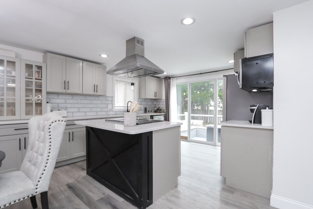 a kitchen with kitchen island granite countertop a sink stainless steel appliances and cabinets