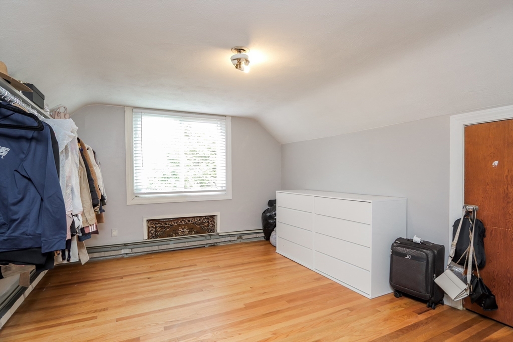 143 Redlands Street Springfield, MA 01104 - Photo 25 of 38 a bedroom with a bed and wooden floor