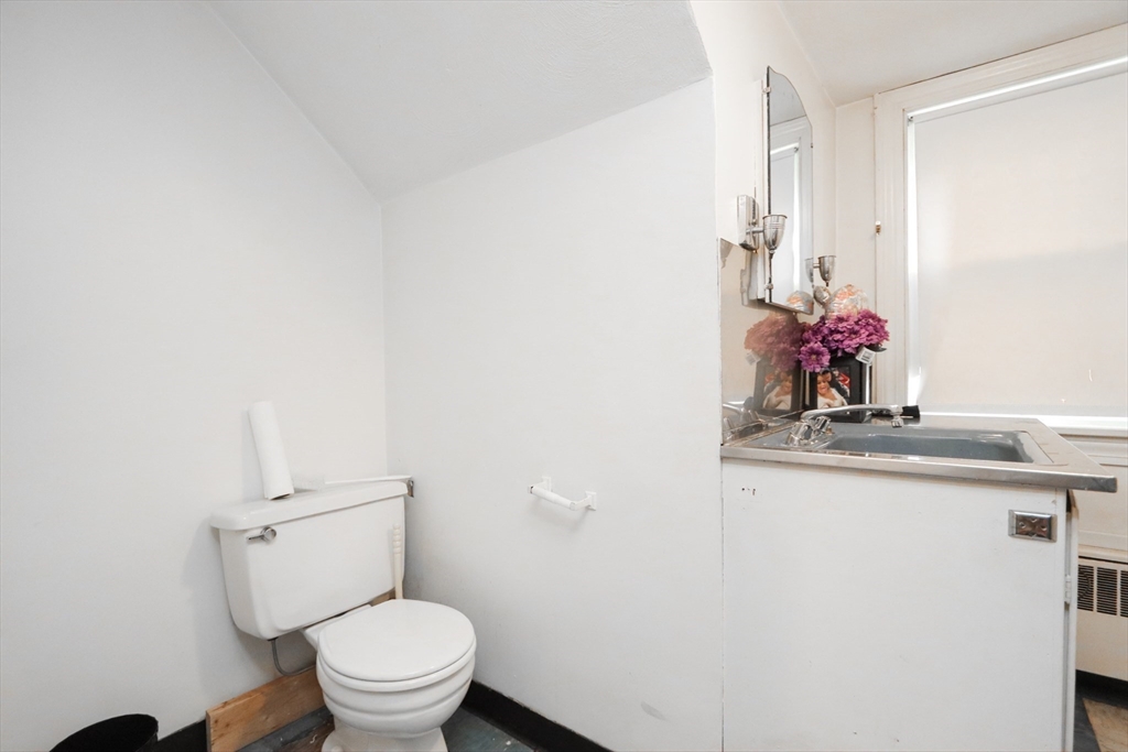 143 Redlands Street Springfield, MA 01104 - Photo 26 of 38 a bathroom with a sink vanity mirror and toilet