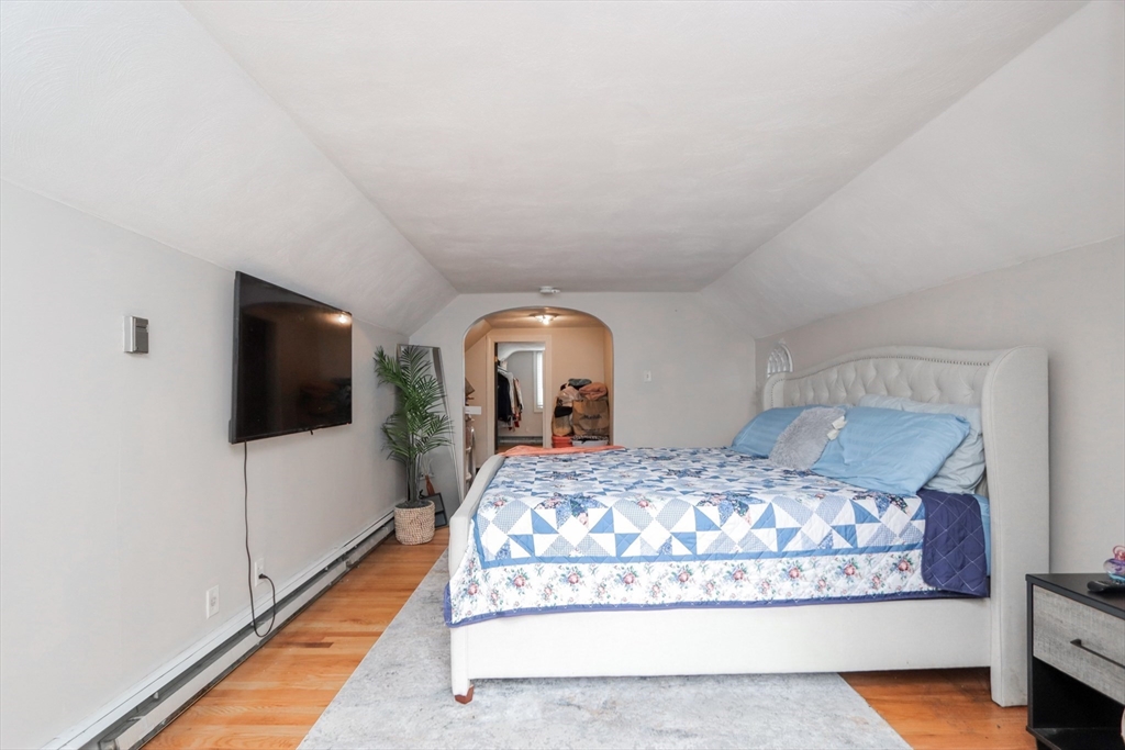 143 Redlands Street Springfield, MA 01104 - Photo 28 of 38 a bedroom with a large bed and a flat tv screen on dresser