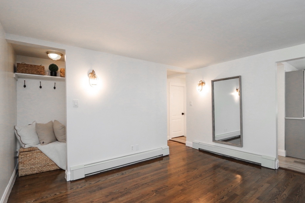 143 Redlands Street Springfield, MA 01104 - Photo 32 of 38 a view of a hallway with wooden floor and cabinet