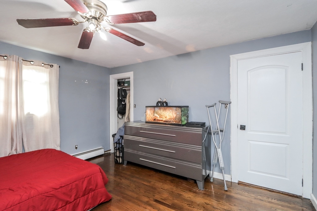 143 Redlands Street Springfield, MA 01104 - Photo 34 of 38 a bedroom with a bed and a chandelier