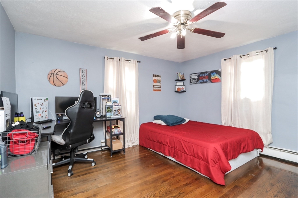 143 Redlands Street Springfield, MA 01104 - Photo 35 of 38 a bedroom with a bed and a chandelier