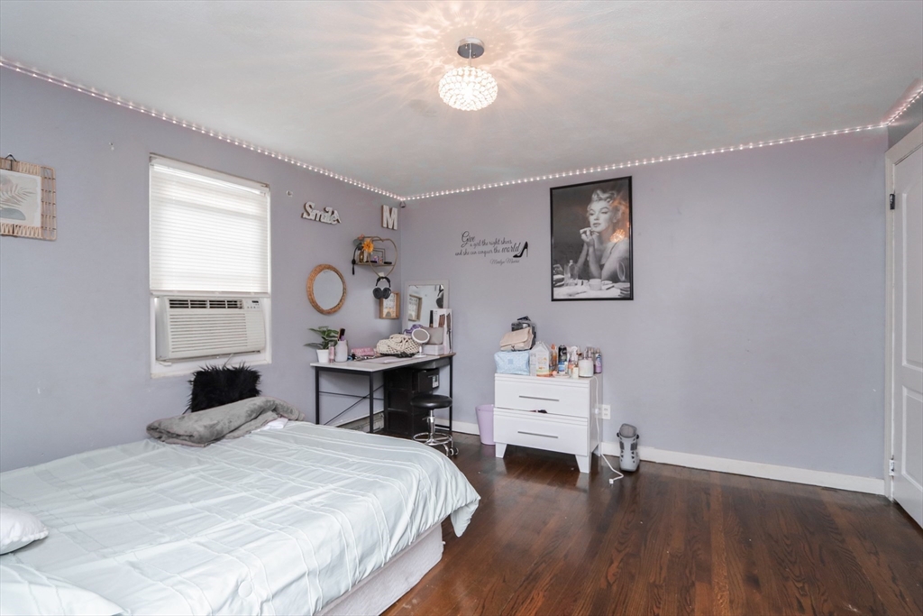 143 Redlands Street Springfield, MA 01104 - Photo 36 of 38 a bedroom with a bed and wooden floor