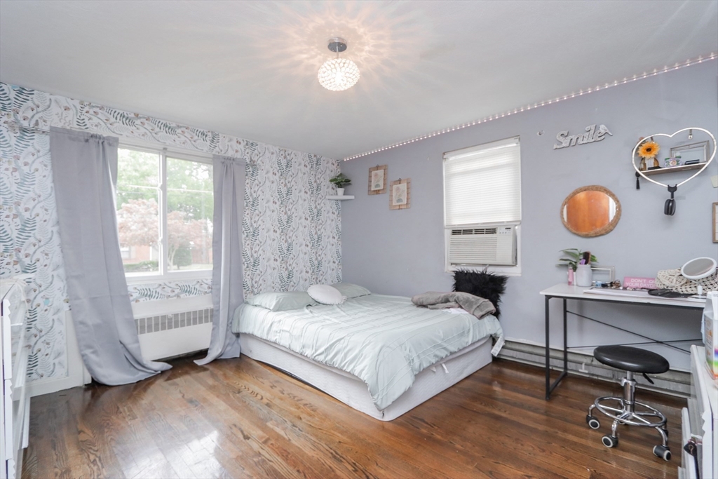 143 Redlands Street Springfield, MA 01104 - Photo 37 of 38 a bedroom with a bed and a chandelier
