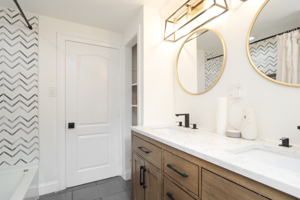 143 Redlands Street Springfield, MA 01104 - Photo 38 of 38 a bathroom with a sink and a mirror