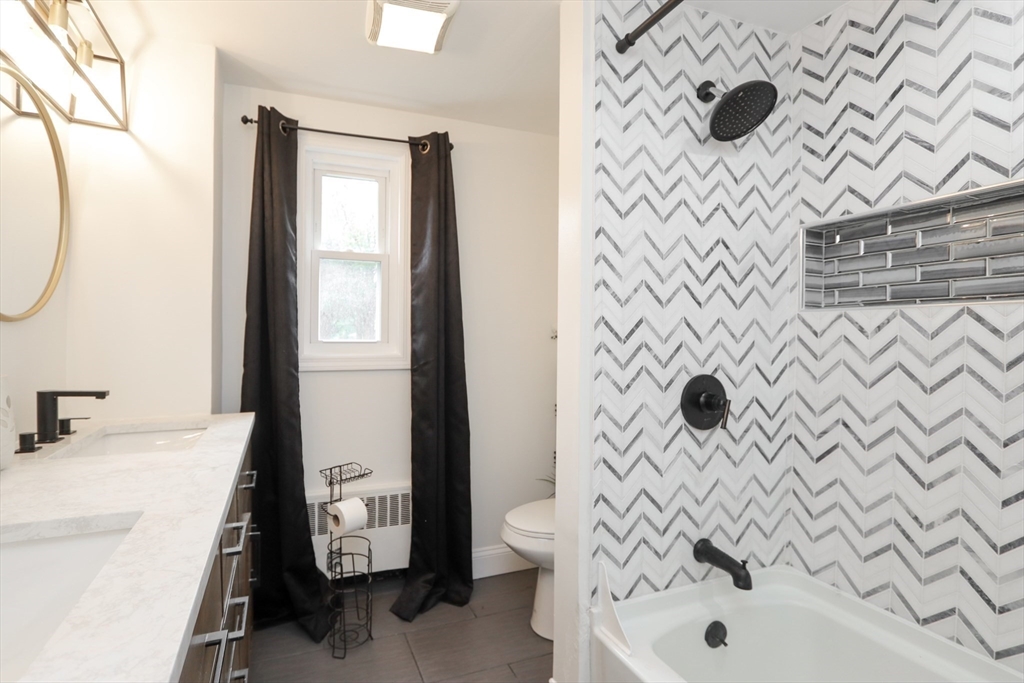 143 Redlands Street Springfield, MA 01104 - Photo 5 of 38 a bathroom with a sink and a shower curtain