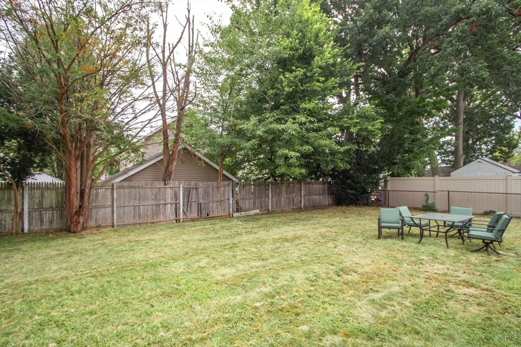 143 Redlands Street Springfield, MA 01104 - Photo 9 of 38 a backyard of a house with table and chairs