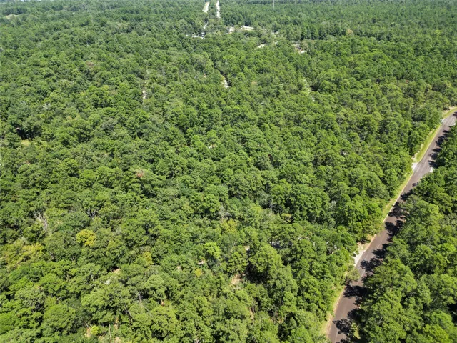 a view of a green field with an ocean view