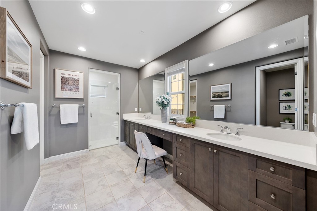 215 Bryce Run Lake Forest, CA 92630 - Photo 16 of 33 a hall with stainless steel appliances kitchen island granite countertop a sink and cabinets