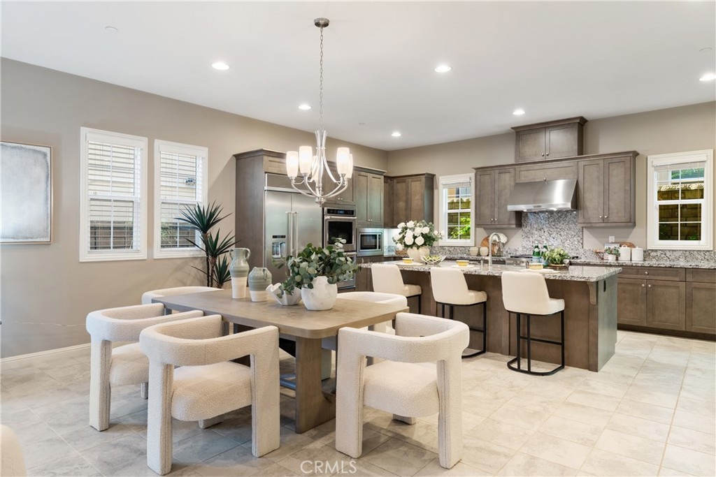 215 Bryce Run Lake Forest, CA 92630 - Photo 7 of 33 a kitchen with a dining table chairs and view kitchen