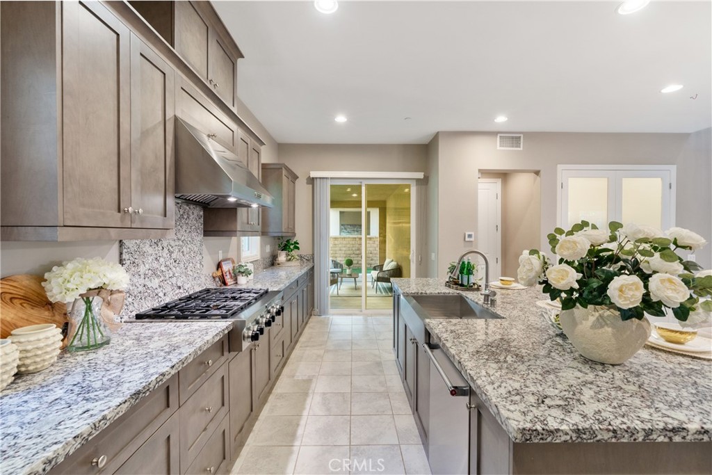 215 Bryce Run Lake Forest, CA 92630 - Photo 10 of 33 a large kitchen with granite countertop a lot of white cabinets