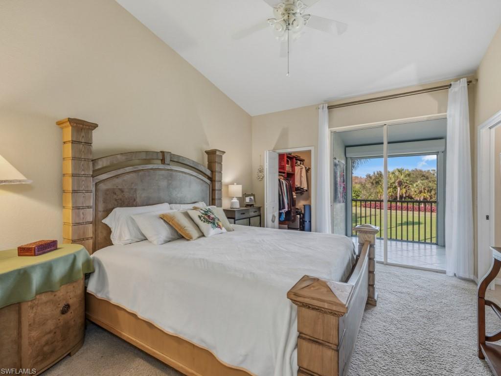6095 Pinnacle Lane, Unit 1304 Naples, FL 34110 - Photo 12 of 47 a bedroom with a bed and a table