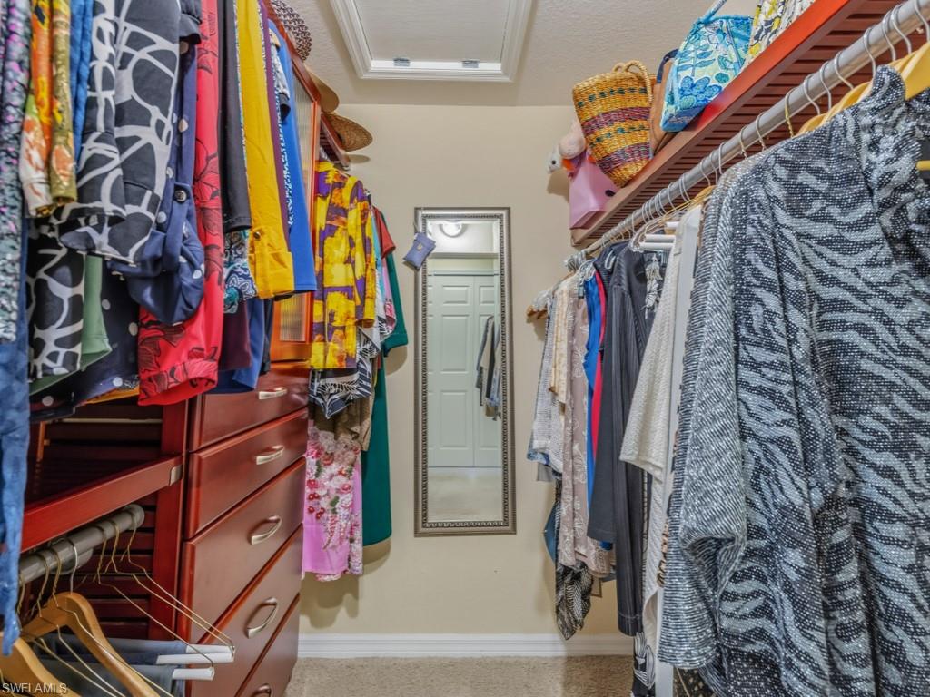 6095 Pinnacle Lane, Unit 1304 Naples, FL 34110 - Photo 14 of 47 a view of walk in closet with clothes and shoes