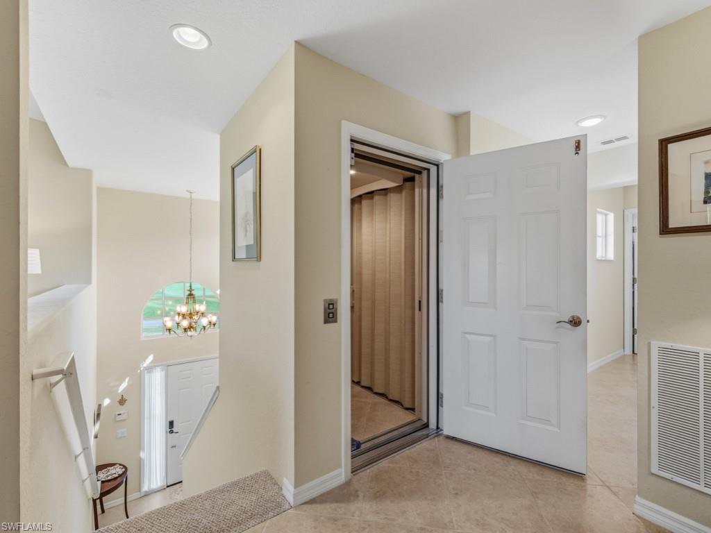 6095 Pinnacle Lane, Unit 1304 Naples, FL 34110 - Photo 2 of 47 a view of an entryway with wooden floor