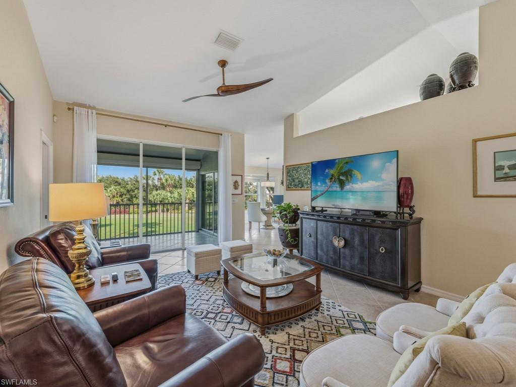 6095 Pinnacle Lane, Unit 1304 Naples, FL 34110 - Photo 6 of 47 a living room with furniture and a large window