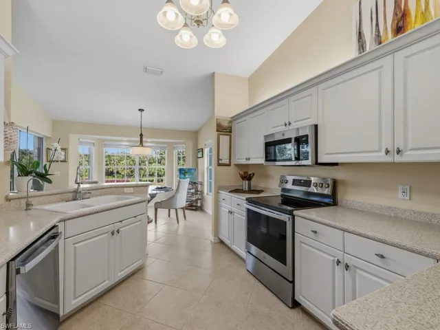 a kitchen with stainless steel appliances granite countertop a sink and stove top oven